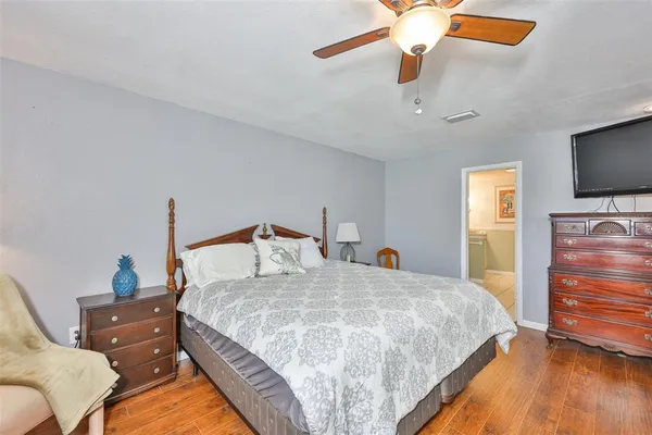a bedroom with a bed and a flat screen tv