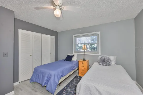 a bedroom with a large bed and a chandelier