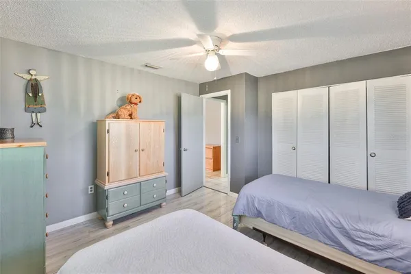 a bedroom with a large bed and a chandelier