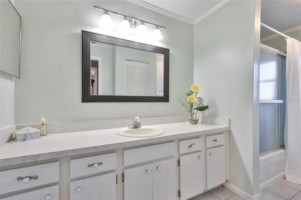 a bathroom with a double vanity sink and a mirror