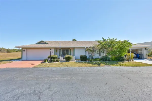 a front view of a house with a yard and a garage