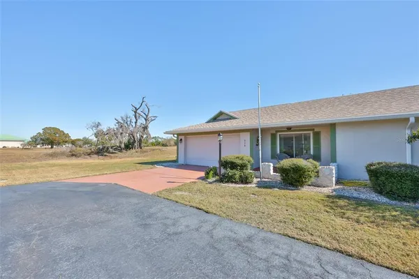 a view of house with outdoor space and swimming pool