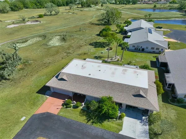 an aerial view of a house with a yard basket ball court and outdoor seating