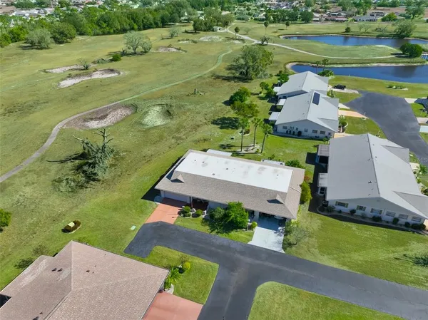 an aerial view of a house with a yard basket ball court and outdoor seating