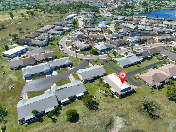an aerial view of residential houses with outdoor space
