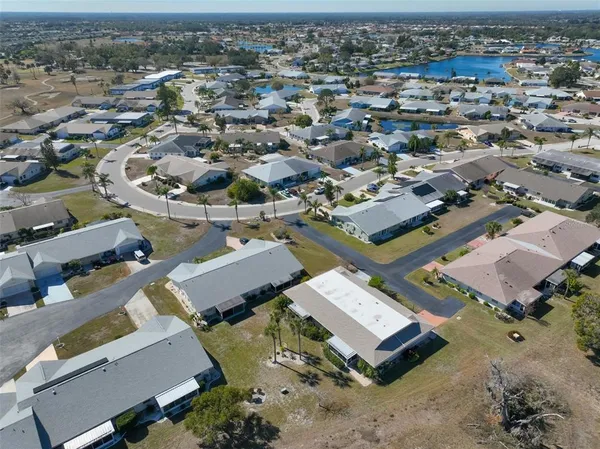 an aerial view of a residential houses with city view