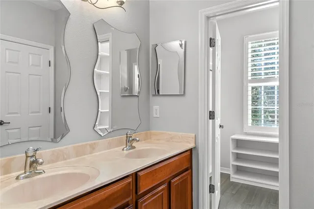 a bathroom with a double vanity sink and a mirror