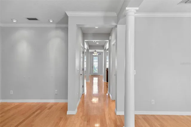 a view of a hallway with wooden floor