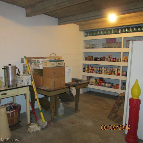 3901 Industry Road Rootstown, OH 44272 - Photo 19 of 22 The basement is partially finished but very large! Here is an area under the porch for canning and an extra freezer.