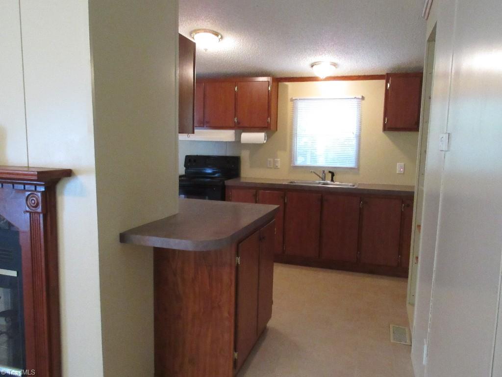 1019 Chisholm Road Ramseur, NC 27316 - Photo 3 of 13 Kitchen has new range/oven!