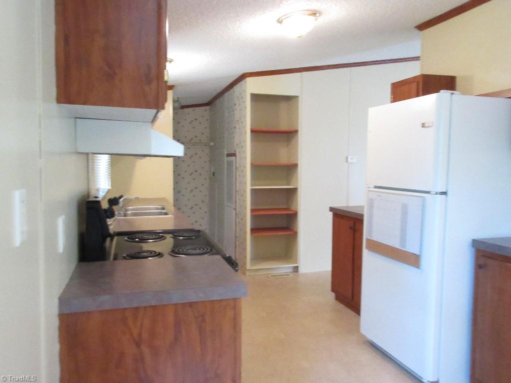 1019 Chisholm Road Ramseur, NC 27316 - Photo 4 of 13 Kitchen access from two sides, great for a small family~
