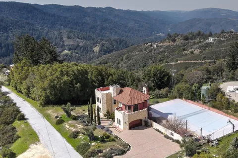 an aerial view of a house with mountain view
