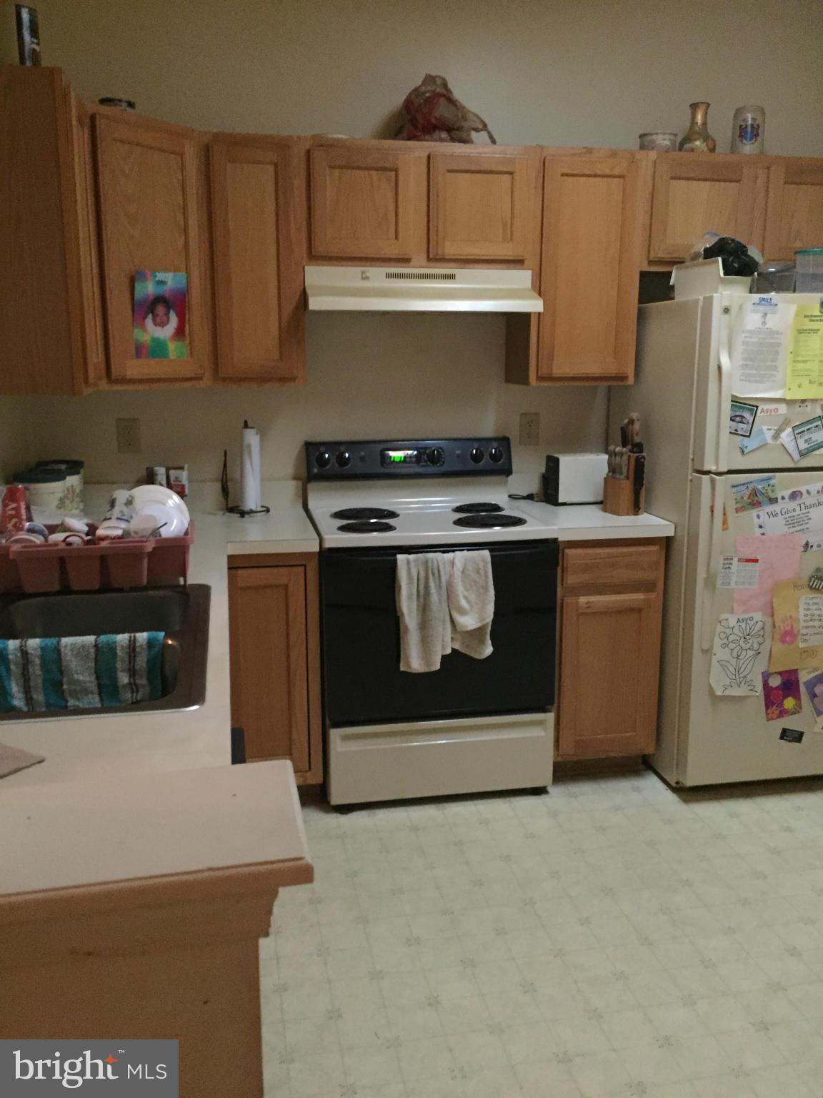 309 Assembly Point Court Odenton, MD 21113 - Photo 2 of 25 a kitchen with stainless steel appliances granite countertop a stove a refrigerator and a cabinets