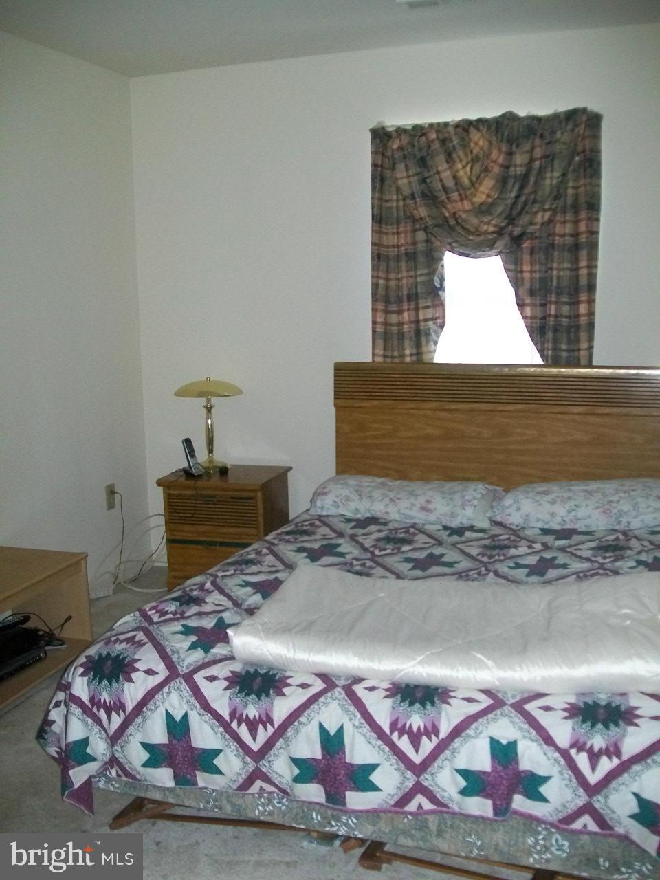 309 Assembly Point Court Odenton, MD 21113 - Photo 16 of 25 a bedroom with a bed and mirror
