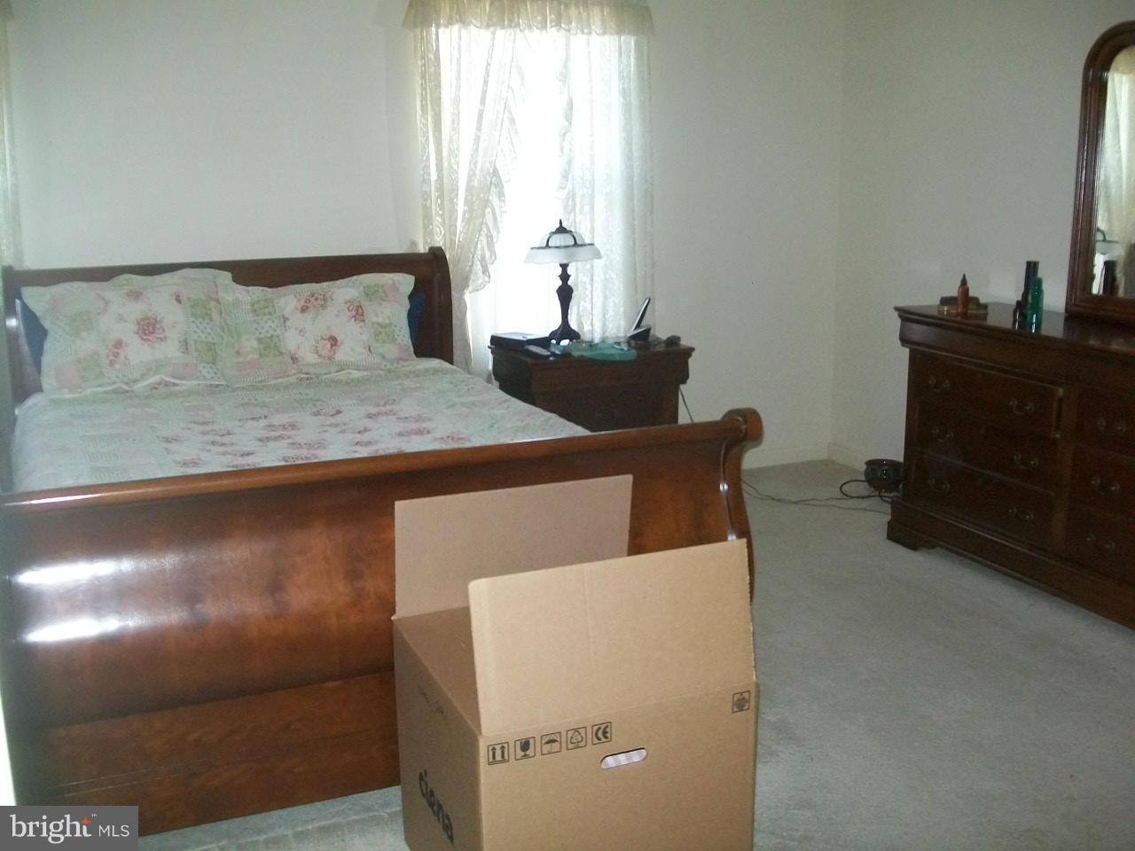 309 Assembly Point Court Odenton, MD 21113 - Photo 17 of 25 a bedroom with a bed and a dresser