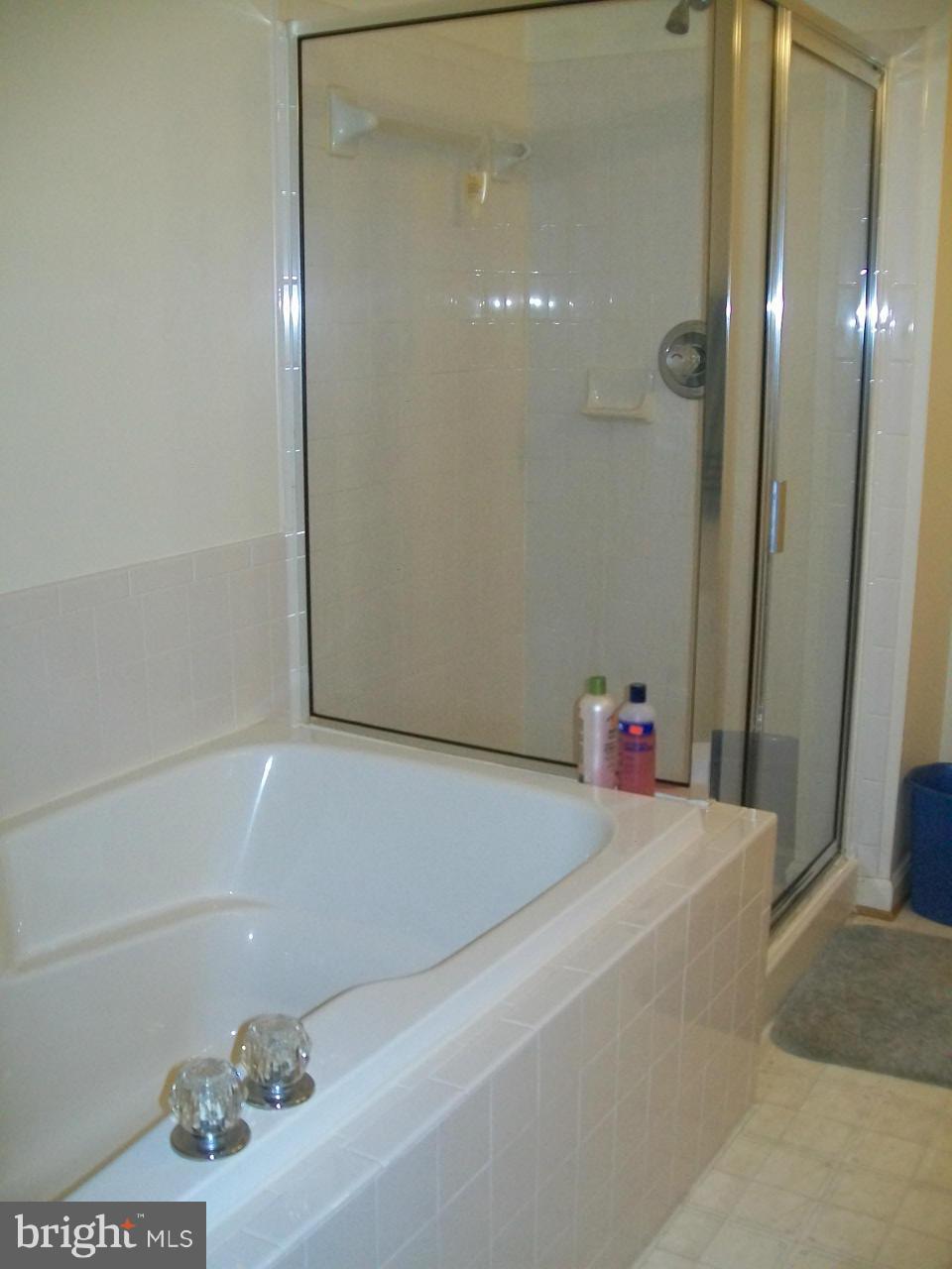 309 Assembly Point Court Odenton, MD 21113 - Photo 22 of 25 a bathroom with a shower and a bath tub