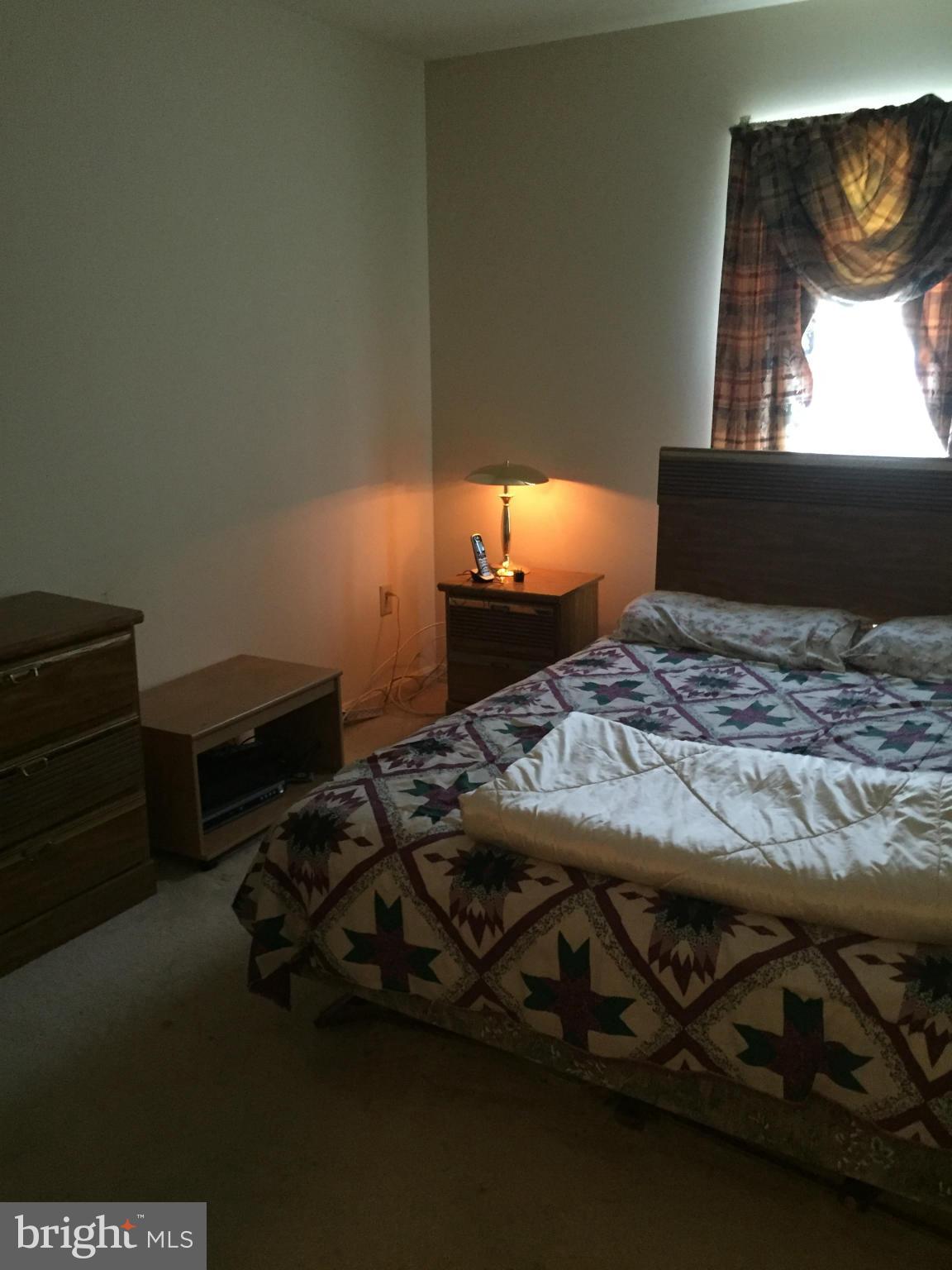 309 Assembly Point Court Odenton, MD 21113 - Photo 24 of 25 a bed sitting in a room next to a window