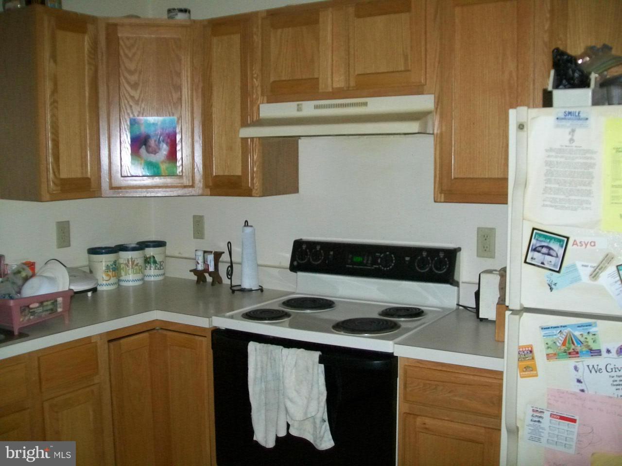 309 Assembly Point Court Odenton, MD 21113 - Photo 5 of 25 a kitchen with stainless steel appliances granite countertop a stove and a refrigerator
