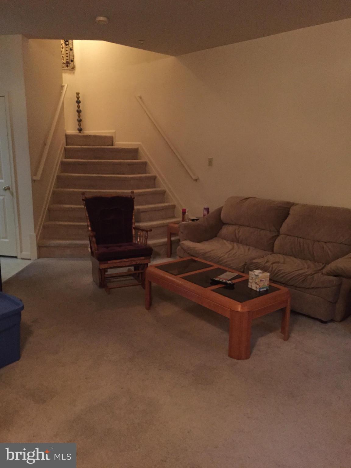 309 Assembly Point Court Odenton, MD 21113 - Photo 8 of 25 a living room with furniture and a stair