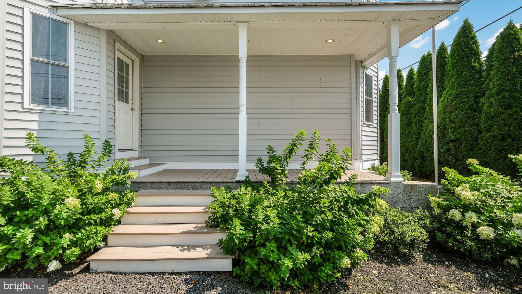5087 Stump Road Pipersville, PA 18947 - Photo 2 of 35 Wide porch entryway with lush greenery.
