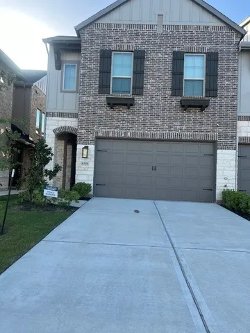 a living room with furniture and large windows