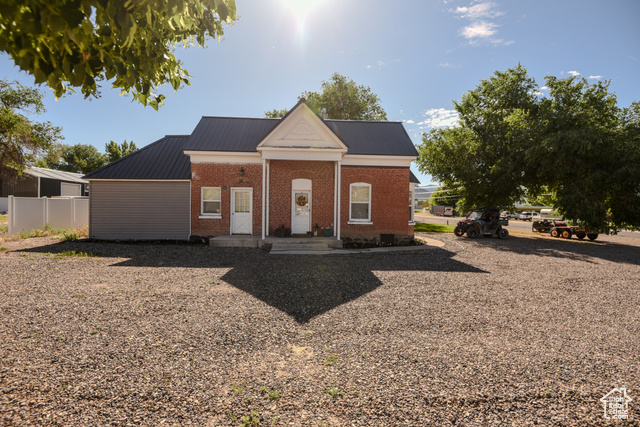 410 North Main Street Beaver, UT 84713 - Photo 1 of 31 Greek revival inspired property featuring brick siding and a metal roof