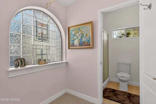 a view of an empty room with chandelier fan