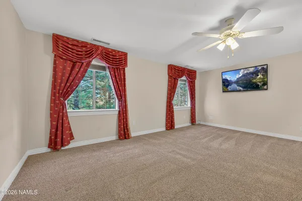 a view of a room with workspace and a window