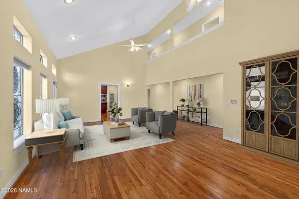 a kitchen with stainless steel appliances kitchen island granite countertop a table chairs and a refrigerator
