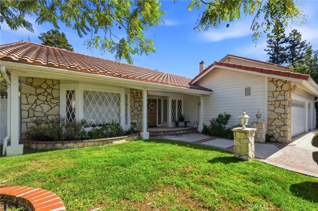 18233 Charlton Lane Porter Ranch, CA 91326 - Photo 4 of 40 a front view of a house with garden