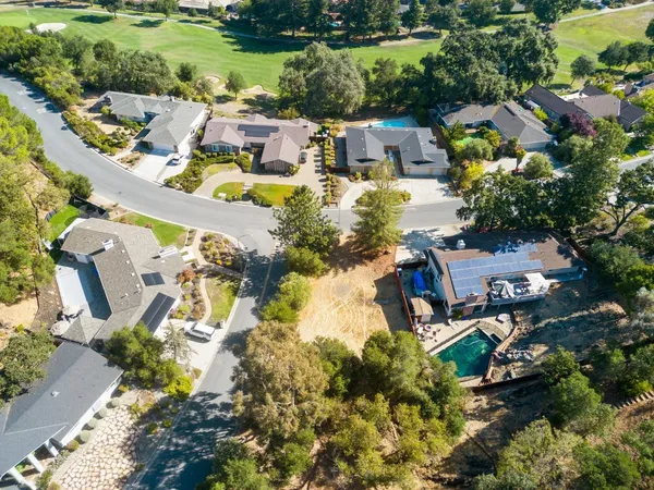 an aerial view of residential house with outdoor space and swimming pool