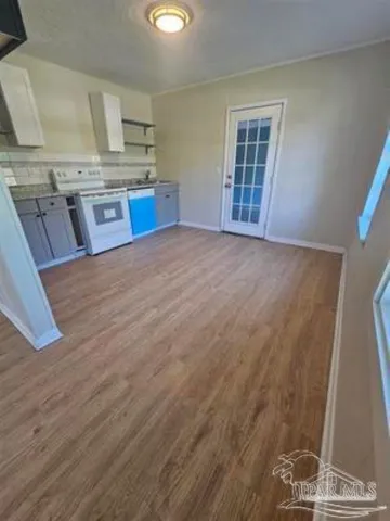 a view of a kitchen with granite countertop cabinets and wooden floor