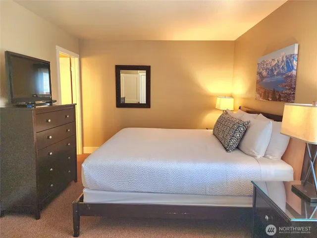 a bedroom with a bed and a flat screen tv