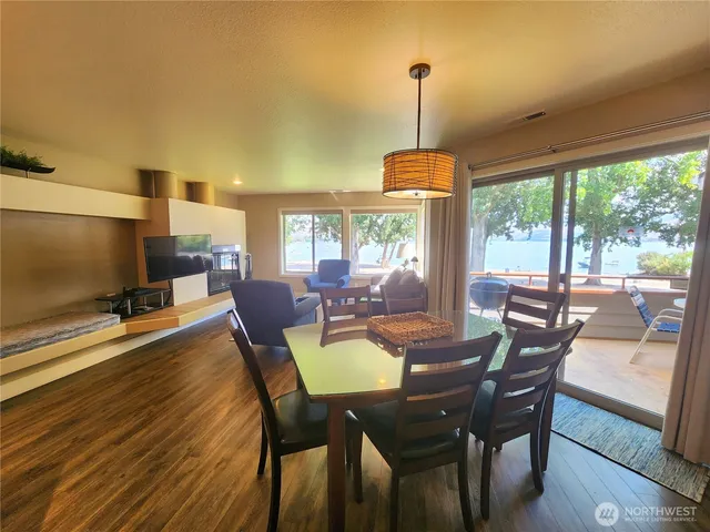 a dining room with furniture a chandelier and wooden floor