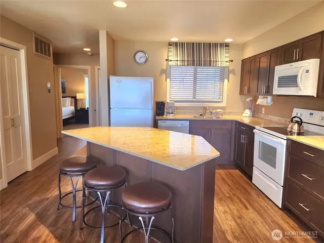 a large kitchen with a table and chairs