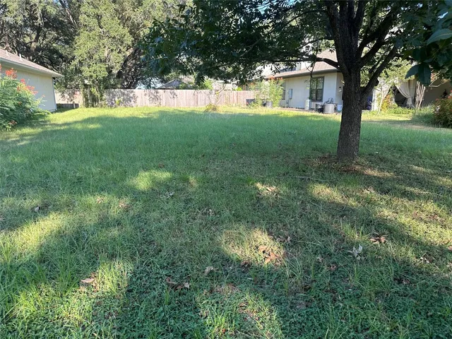 a view of a yard with a tree