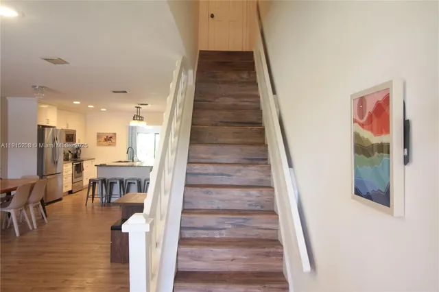 a view of entryway and hall with wooden floor