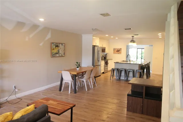 a dining room with furniture and wooden floor