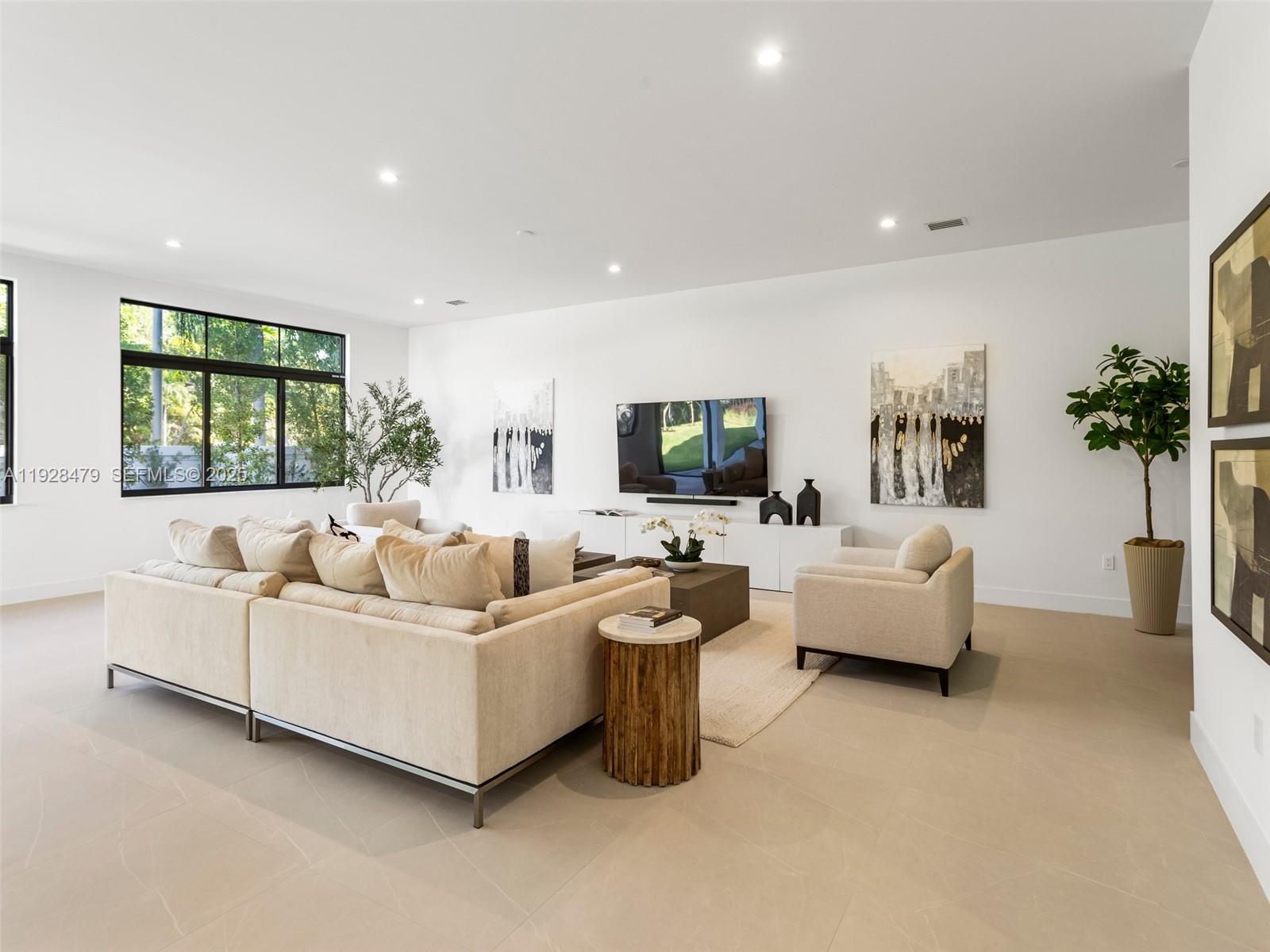 7285 Southwest 72nd Street Miami, FL 33143 - Photo 11 of 53 a living room with furniture and a flat screen tv
