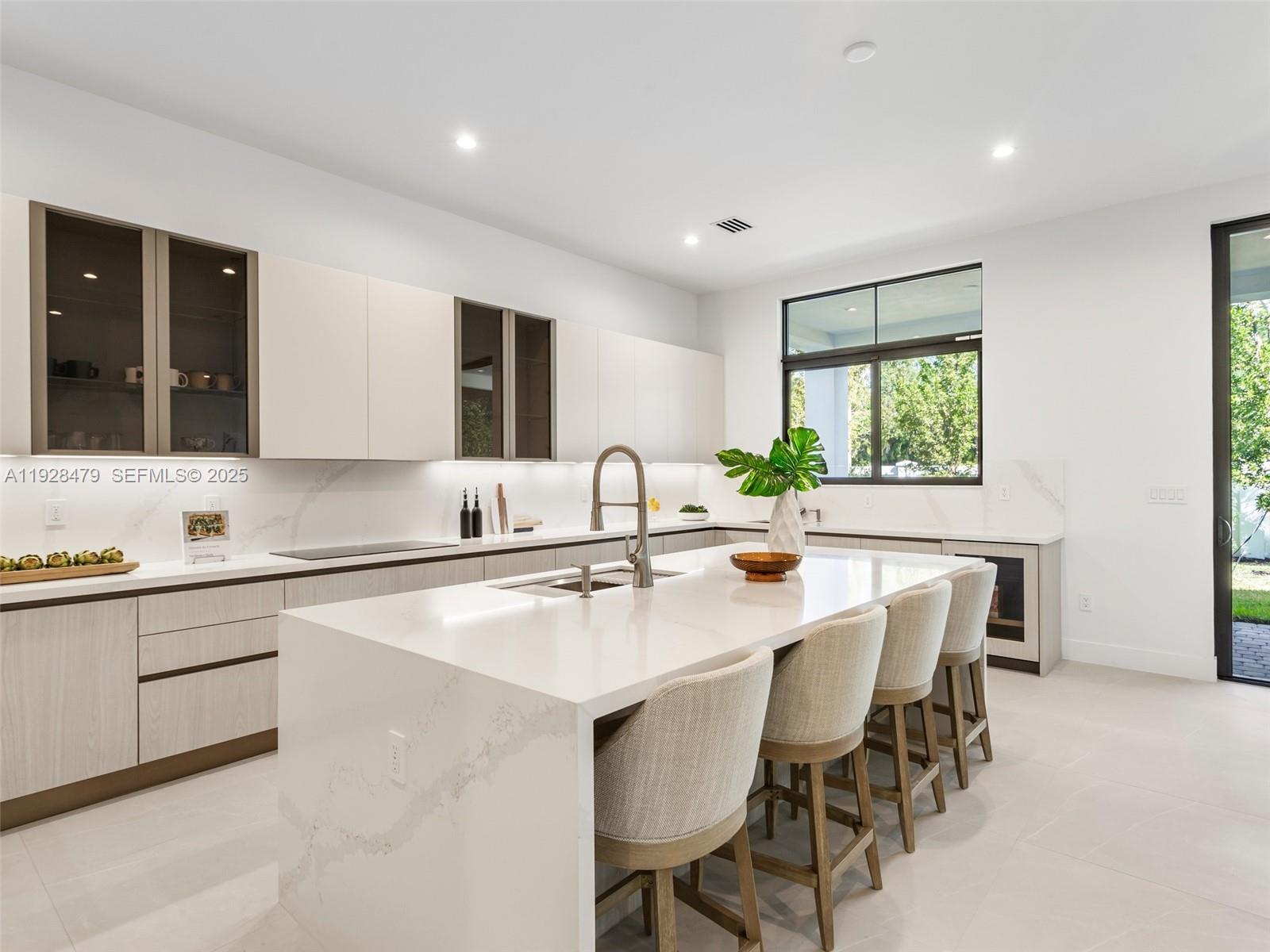 7285 Southwest 72nd Street Miami, FL 33143 - Photo 3 of 53 a kitchen with center island table and chairs in it