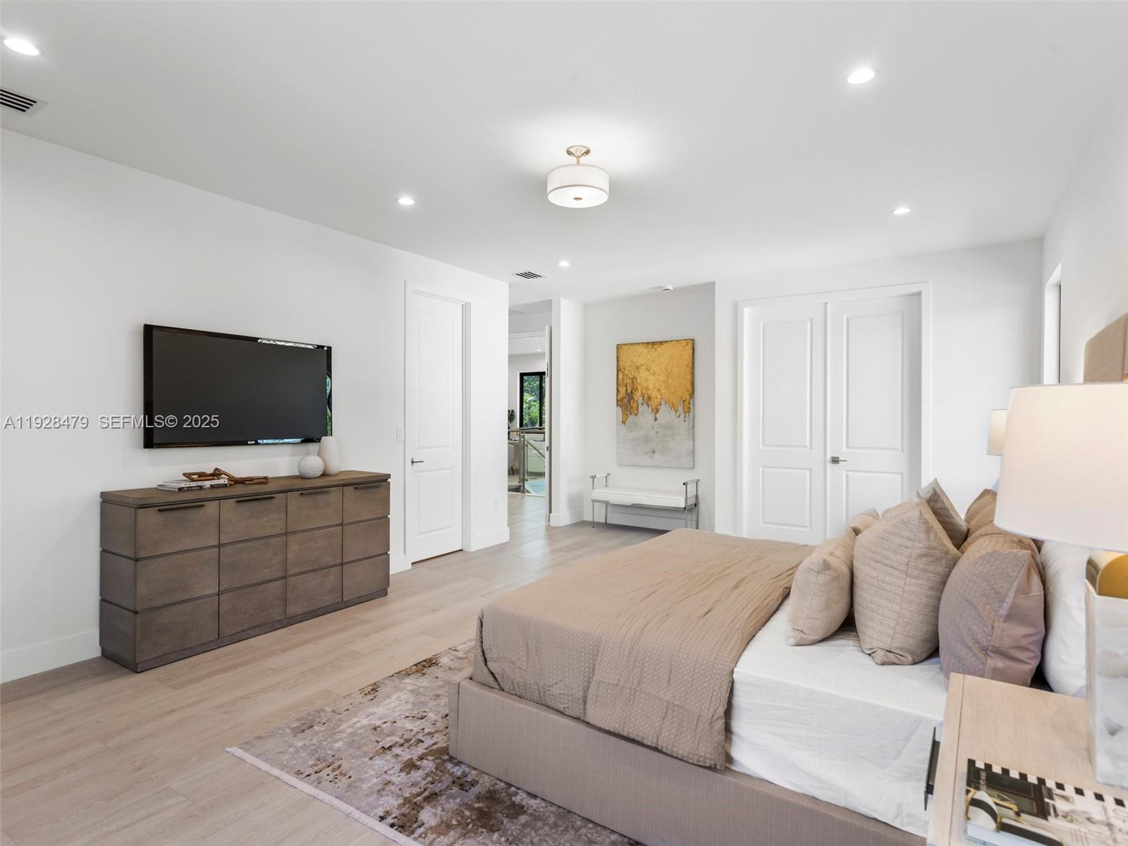 7285 Southwest 72nd Street Miami, FL 33143 - Photo 31 of 53 a bedroom with a bed and a flat screen tv