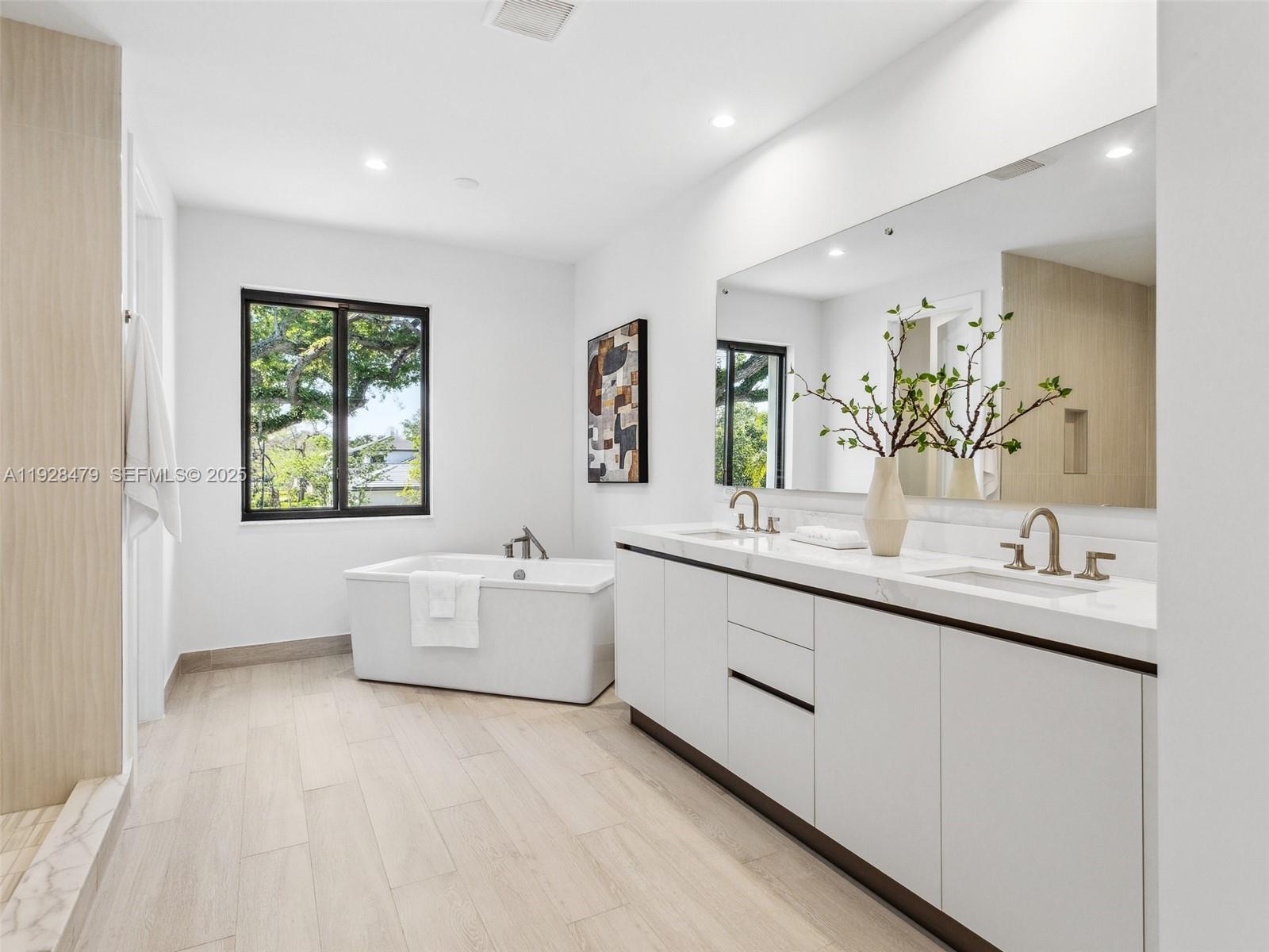 7285 Southwest 72nd Street Miami, FL 33143 - Photo 33 of 53 a bathroom with a granite countertop sink mirror and bathtub