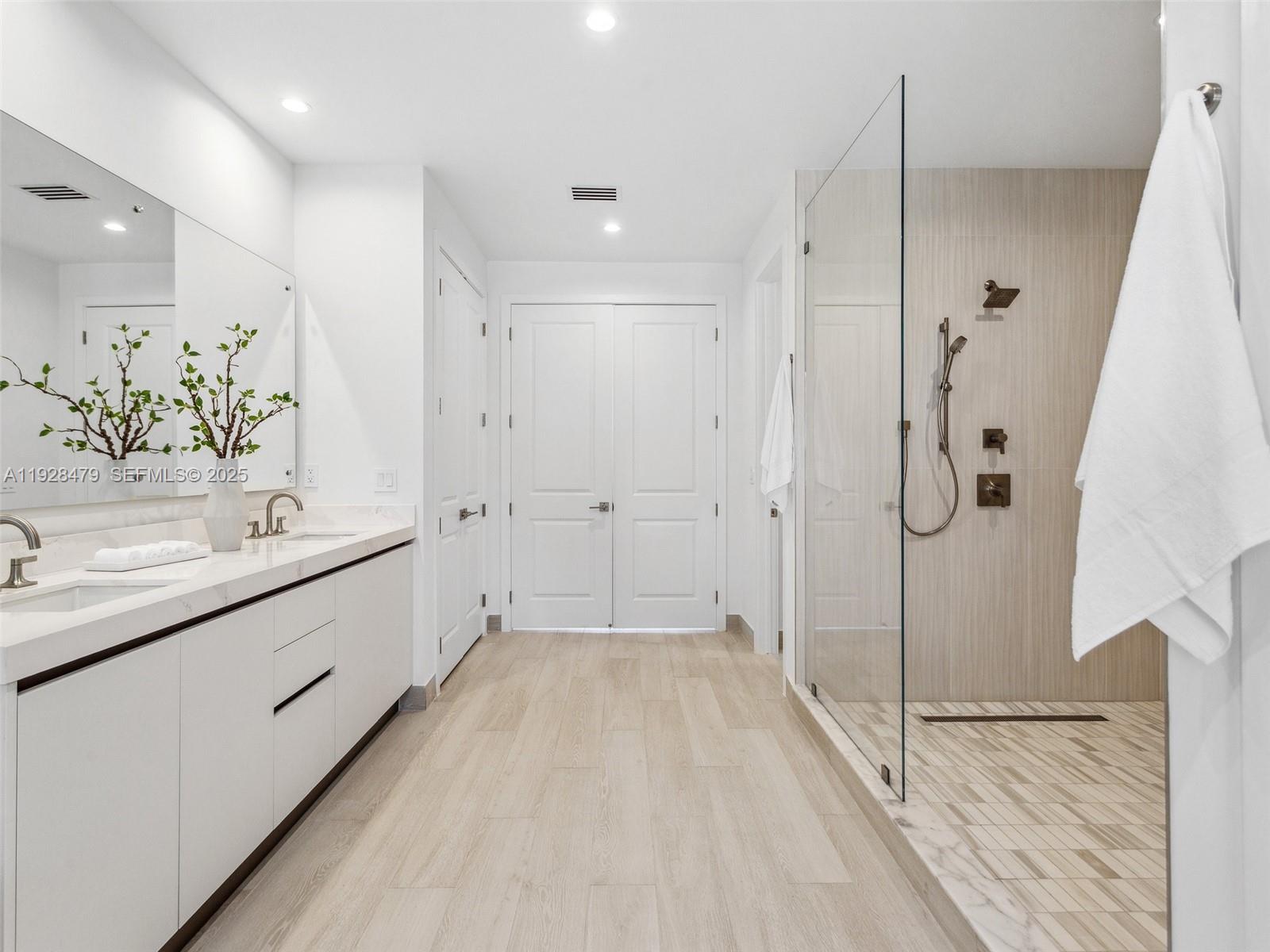7285 Southwest 72nd Street Miami, FL 33143 - Photo 35 of 53 a bathroom with a double vanity sink and mirror