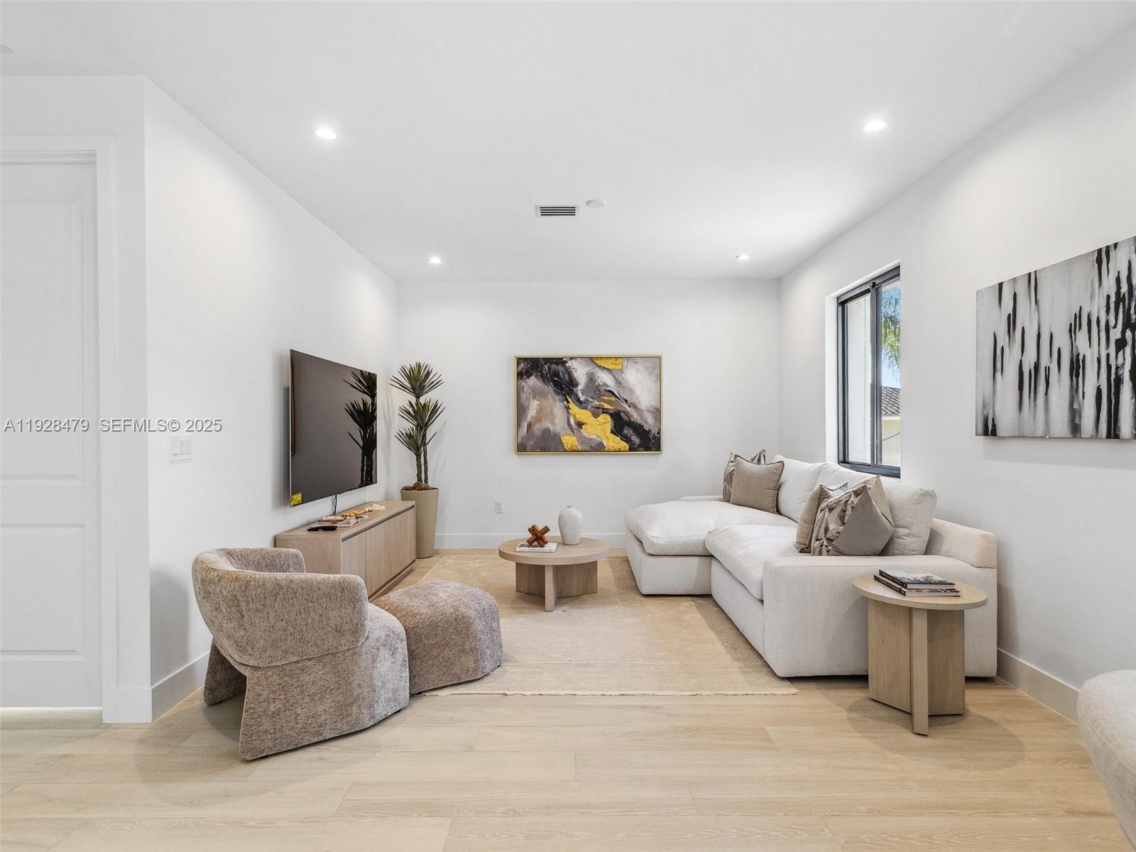 7285 Southwest 72nd Street Miami, FL 33143 - Photo 42 of 53 a living room with furniture and a flat screen tv