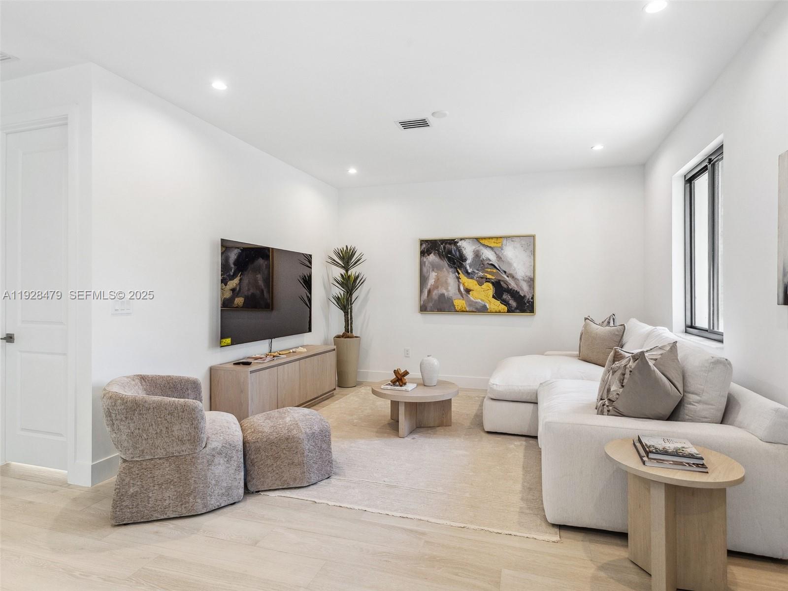 7285 Southwest 72nd Street Miami, FL 33143 - Photo 43 of 53 a living room with furniture and a flat screen tv