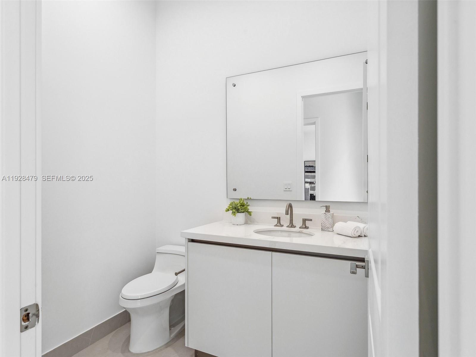 7285 Southwest 72nd Street Miami, FL 33143 - Photo 44 of 53 a bathroom with a sink toilet and mirror