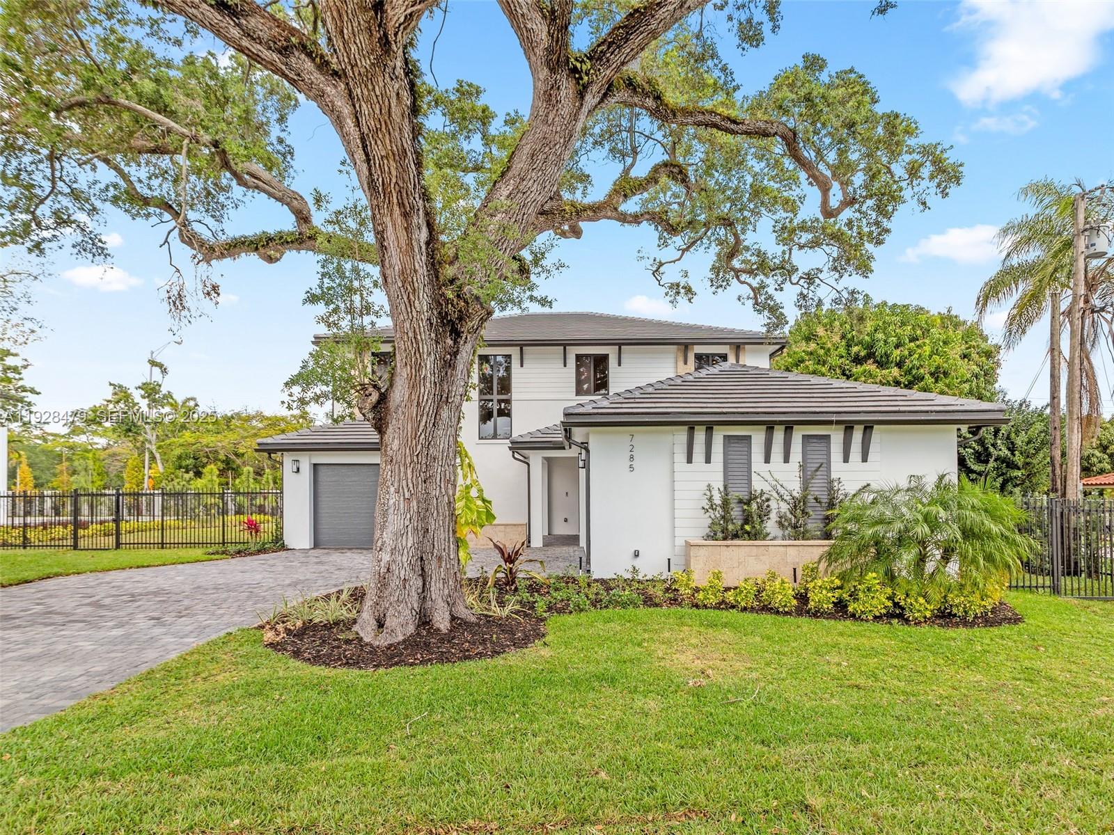7285 Southwest 72nd Street Miami, FL 33143 - Photo 53 of 53 a front view of house with yard and green space