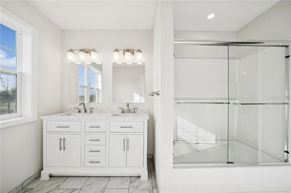 a bathroom with a double vanity sink mirror and