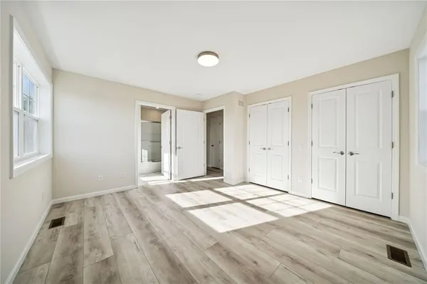 a view of an empty room and wooden floor