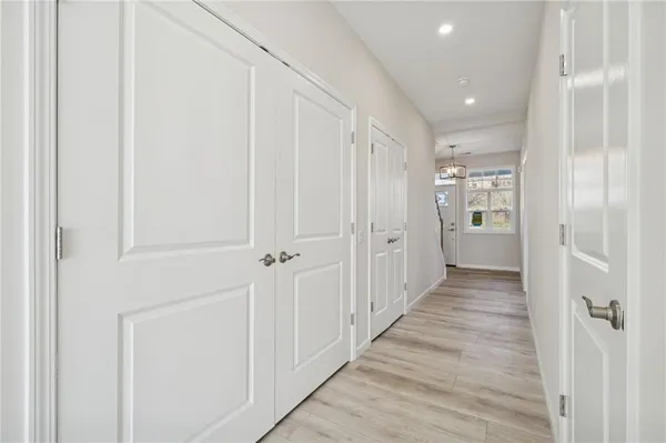 a view of a hallway with wooden floor